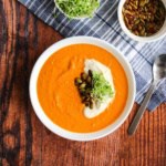 A bowl of tomato chickpea soup on the table ready to eat.