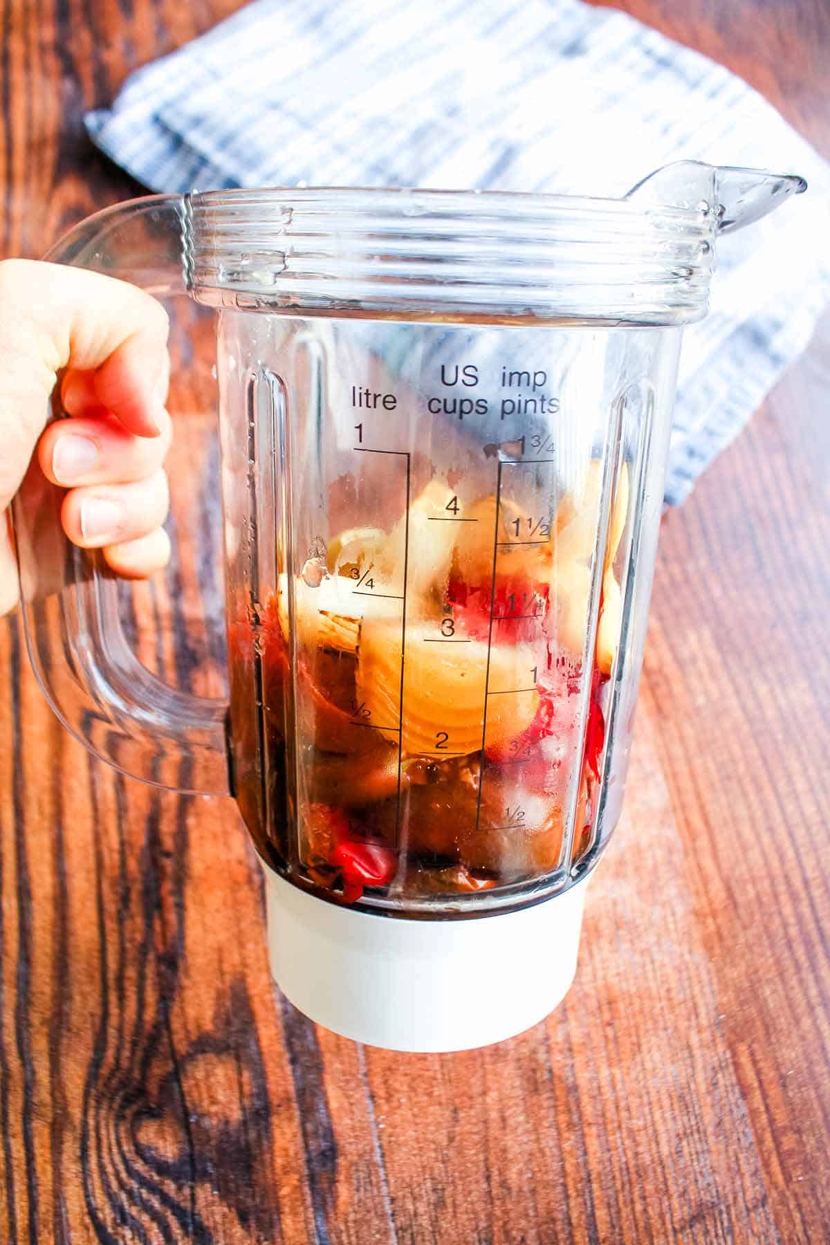 Roasted tomatoes, peppers and onions in a blender to make tomato chickpea soup.