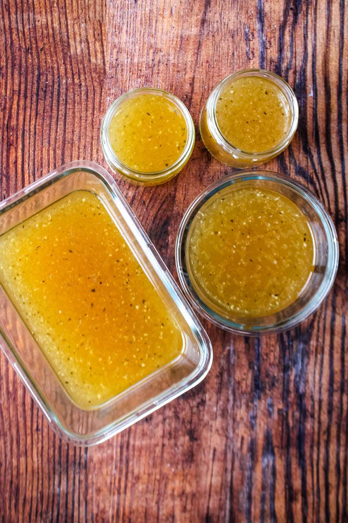 Containers of cooked bone broth on the table ready to store.