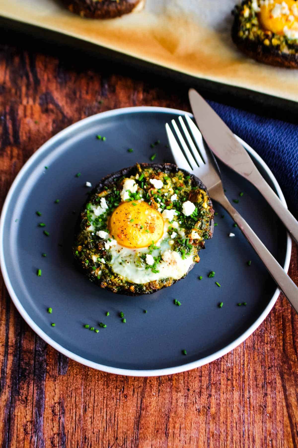 A egg stuffed breakfast mushroom on a plate.