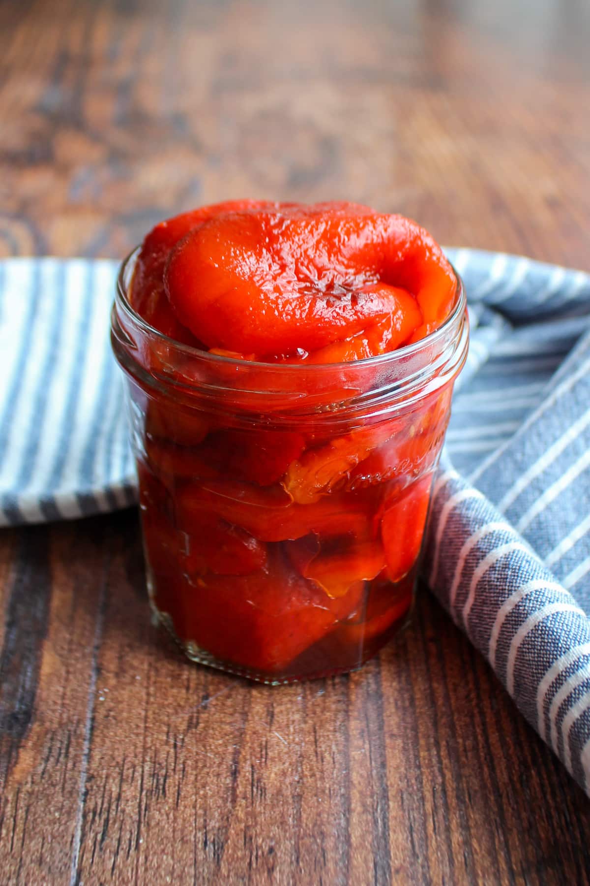 Clear jar overfilled with roasted red peppers