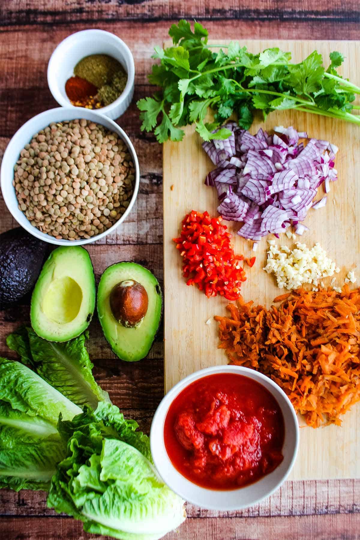 Chopped vegetables on a cutting board to make lentil vegetarian lettuce wraps.