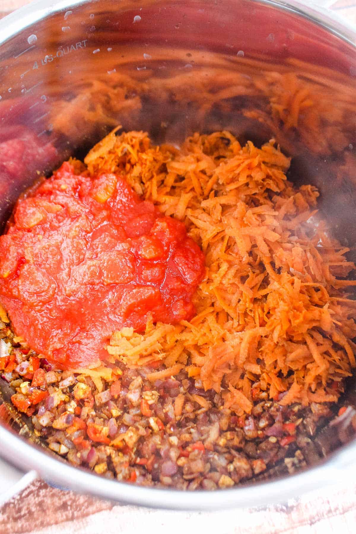 Tomatoes and carrot added to the cooked vegetables.