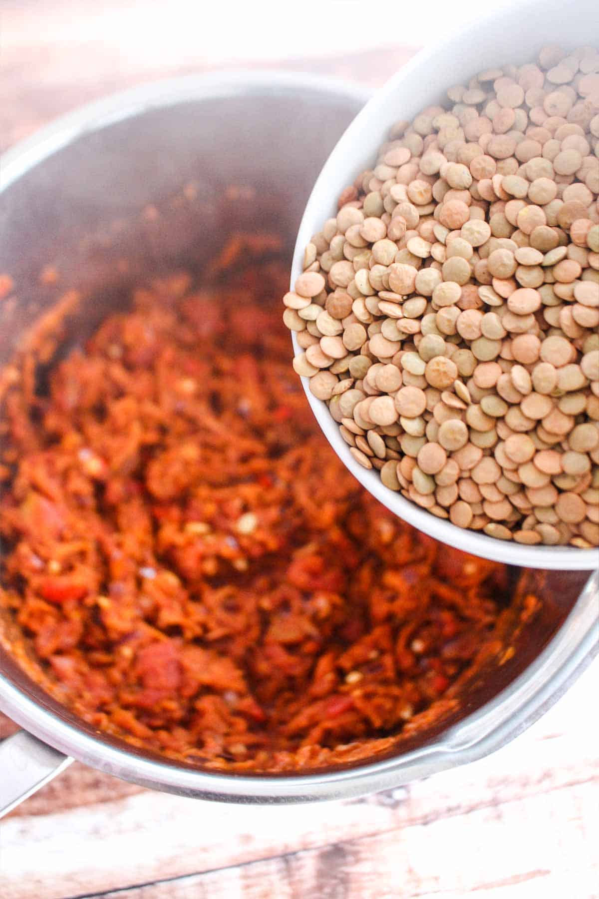 Adding the lentils to the pot.