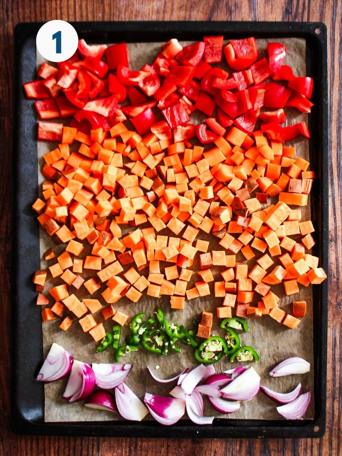 Veggies laid out on a pan to roast in the oven.