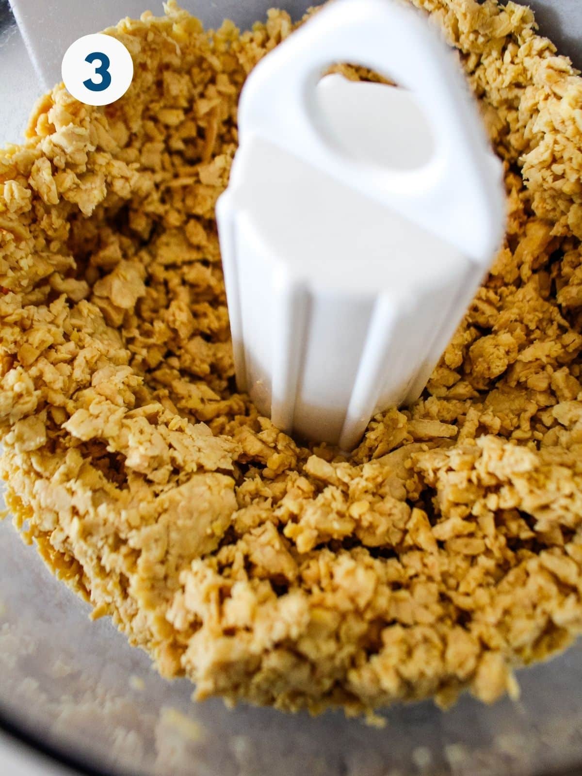 Mashing the tempeh up in a bowl.