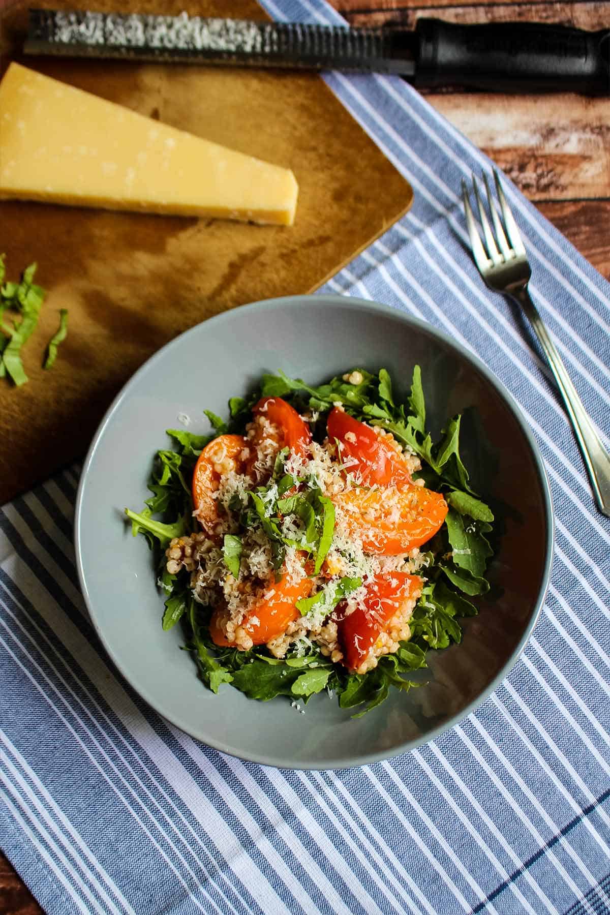 Gluten free salad with sorghum on a plate with tomatoes.