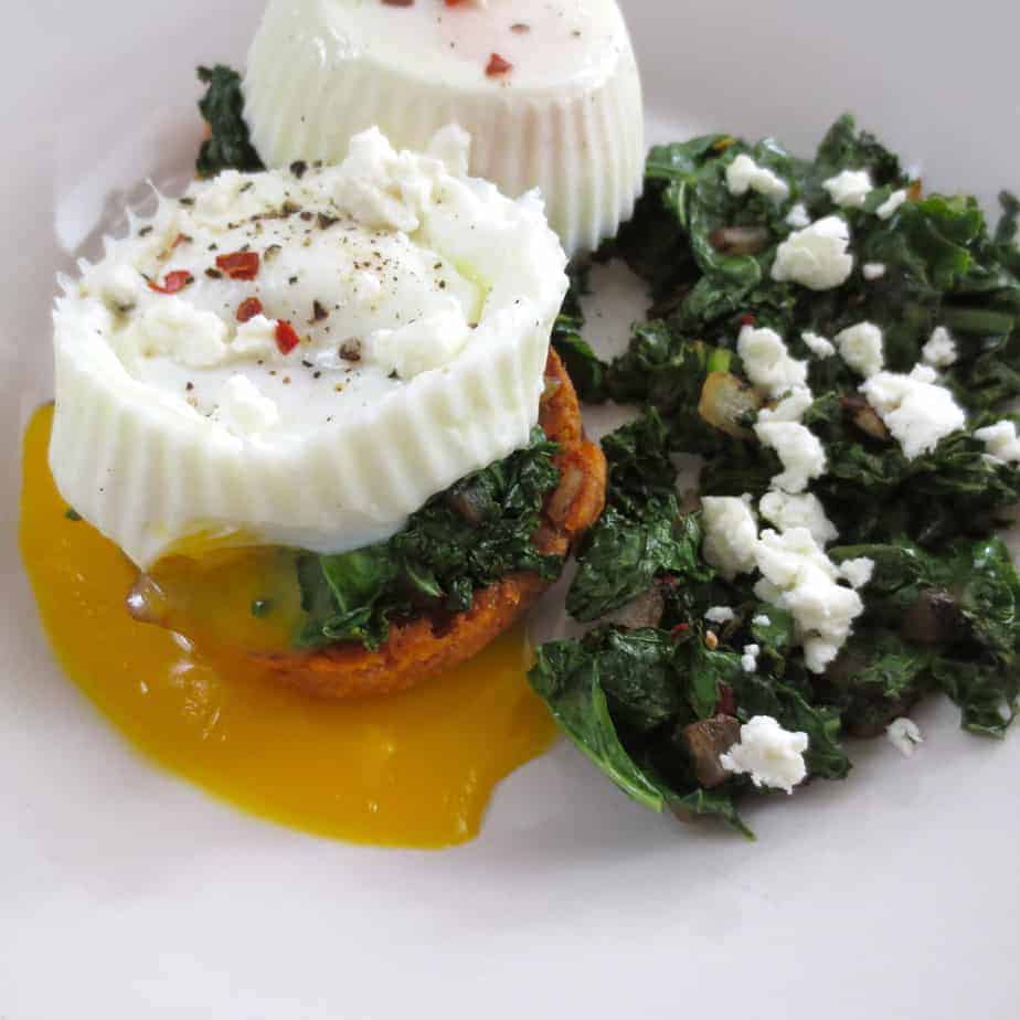 Poached eggs served over vegetables and sprinkled with feta cheese