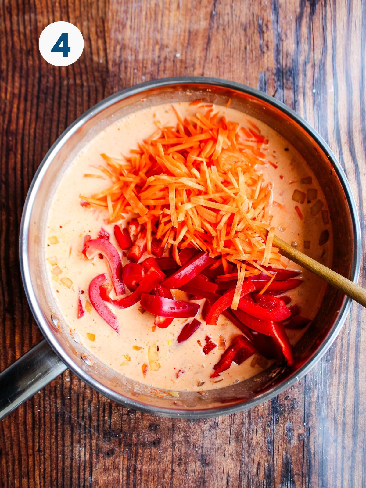 Carrots and red pepper added to the pot.