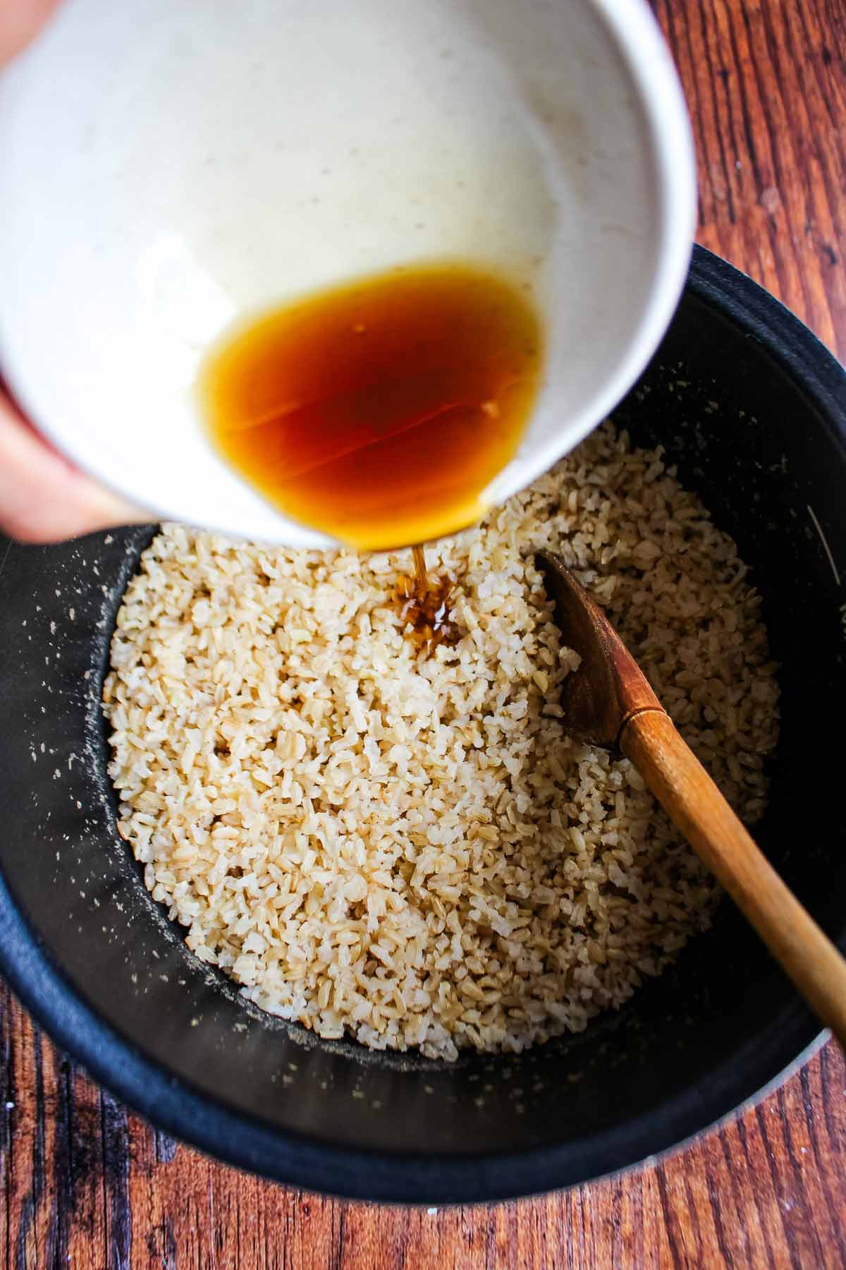 Adding the seasoning mixture to the rice.