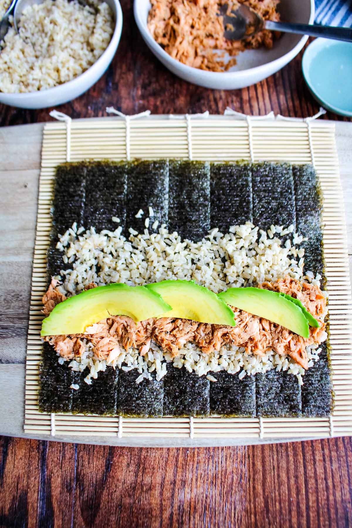 Salmon and avocado arranged on top of the rice.