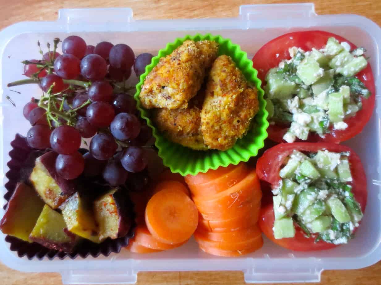 Lunch Box with Stuffed Tomatoes, Almond Crusted Chicken Strips, and Roasted Sweet Potatoes