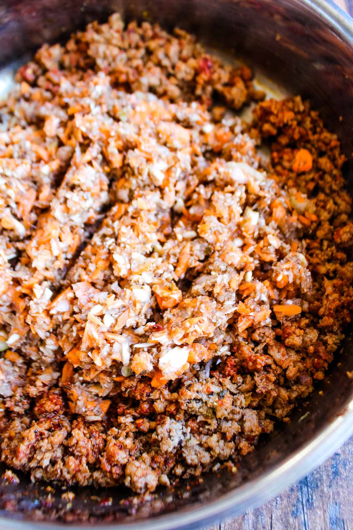 Veggies added to the sausage meat in the skillet.