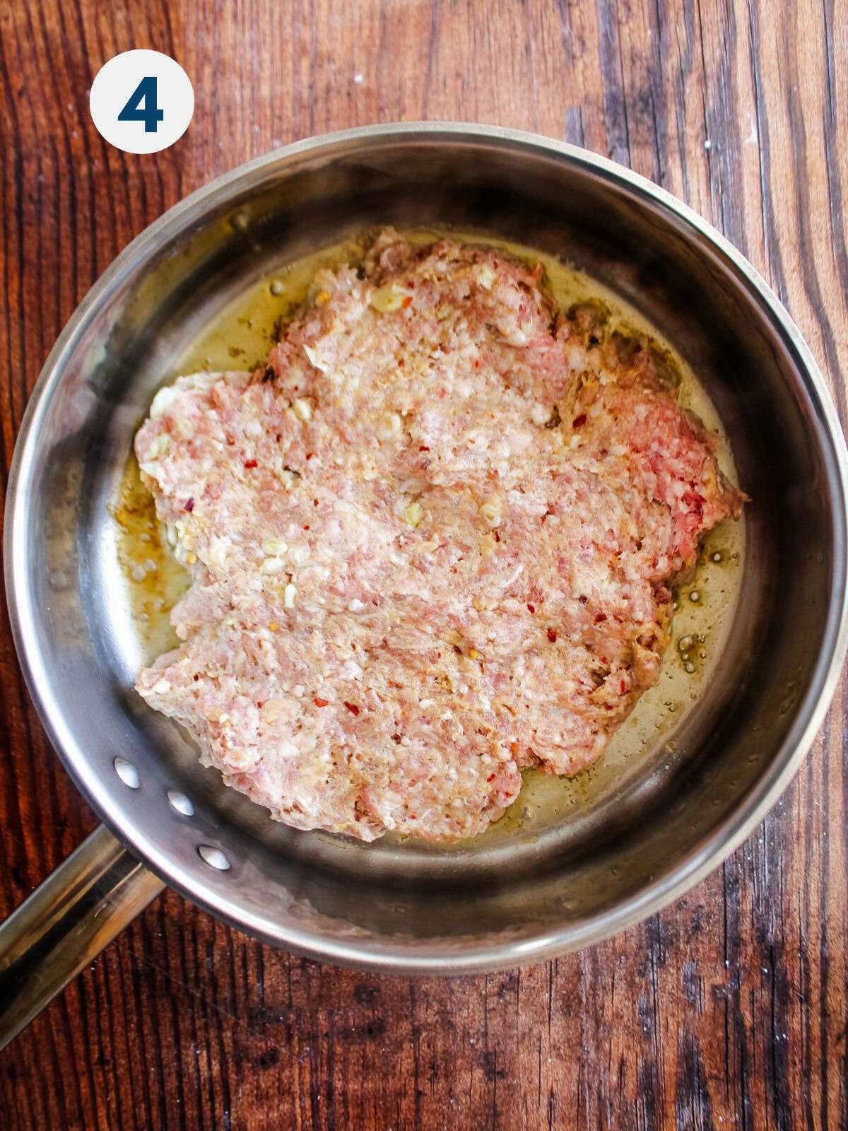 Cooking ground pork in a skillet.