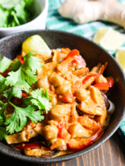 bowl of thai red curry soup with bell peppers and mushrooms