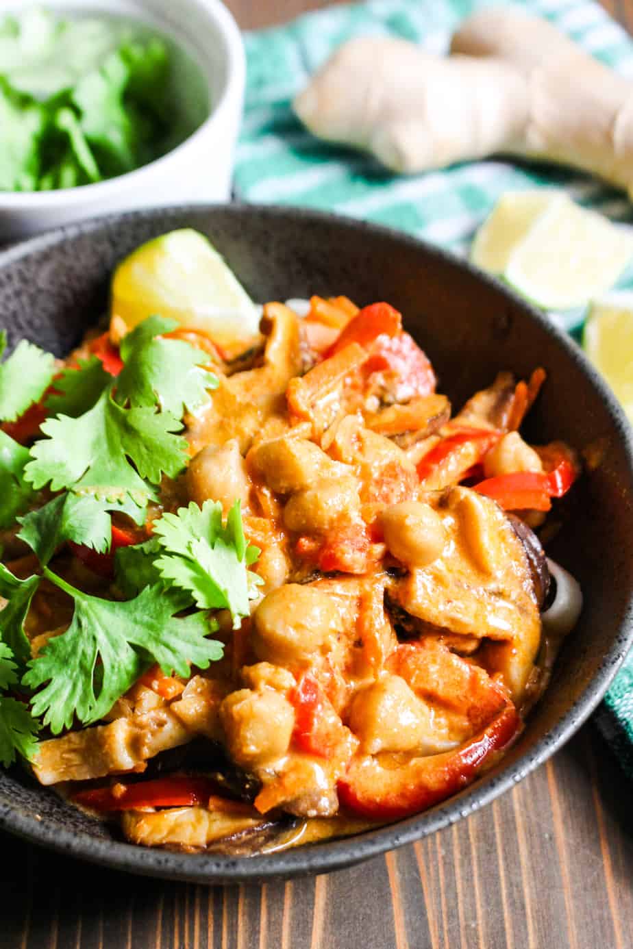 bowl of thai red curry soup with bell peppers and mushrooms