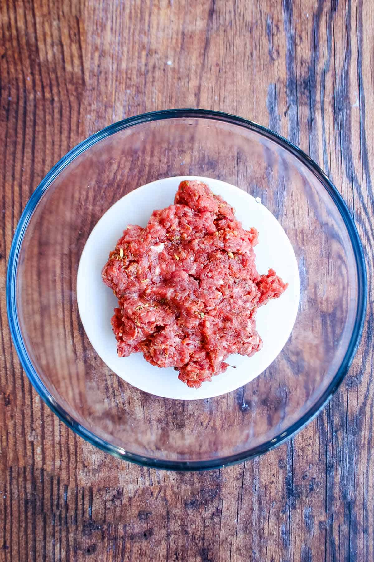 Mixing the ground pork with seasonings to make Italian sausage.