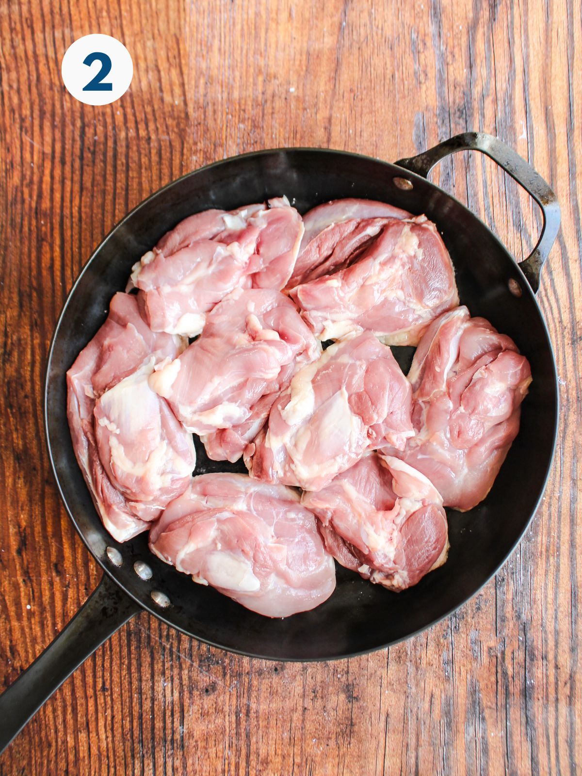 Chicken thighs in the cast iron skillet skin side down.