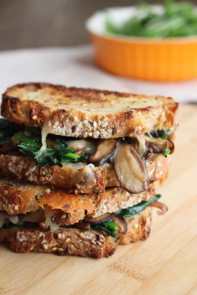 Grilled cheese sandwich with garlic mushrooms, melted cheese, and spinach.