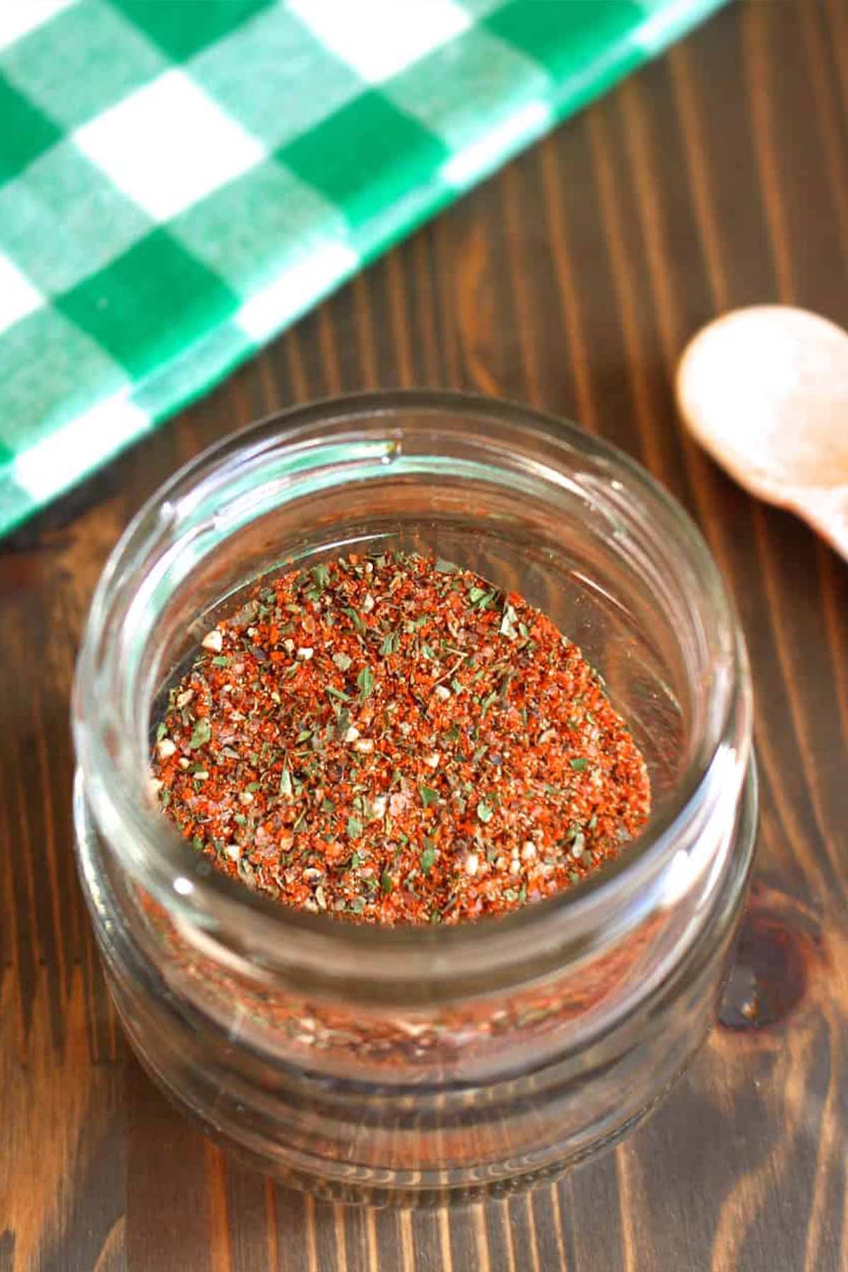 Homemade Italian Sausage Seasoning in a jar on the table.