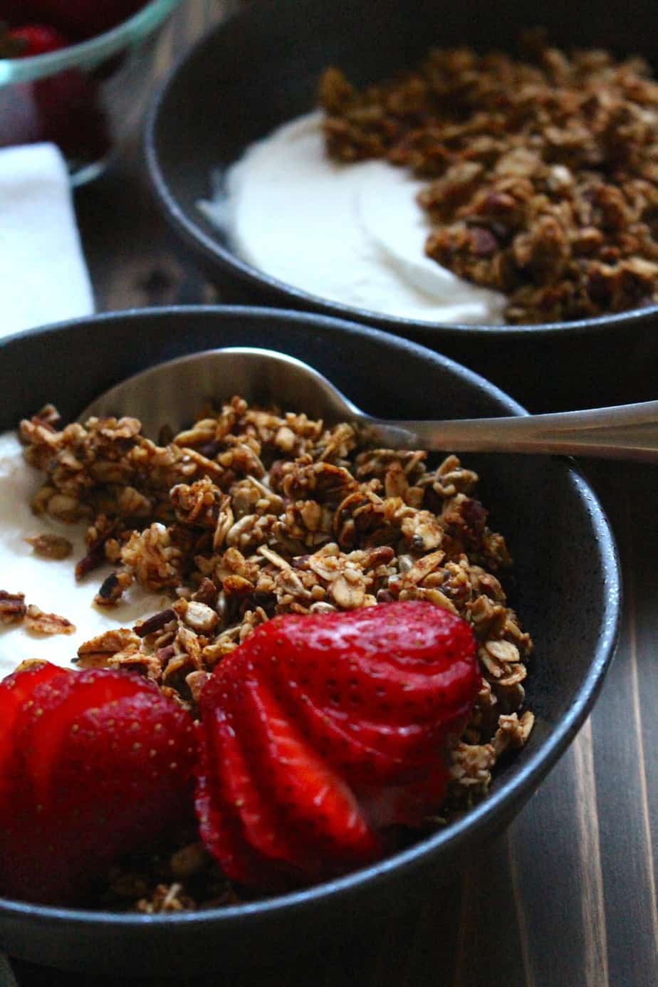 granola in a bowl with yogurt and strawberries