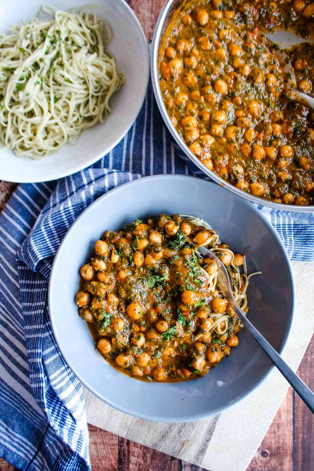 Bowl of 4 ingredient dinner with vegan chickpeas on the table with noodles.