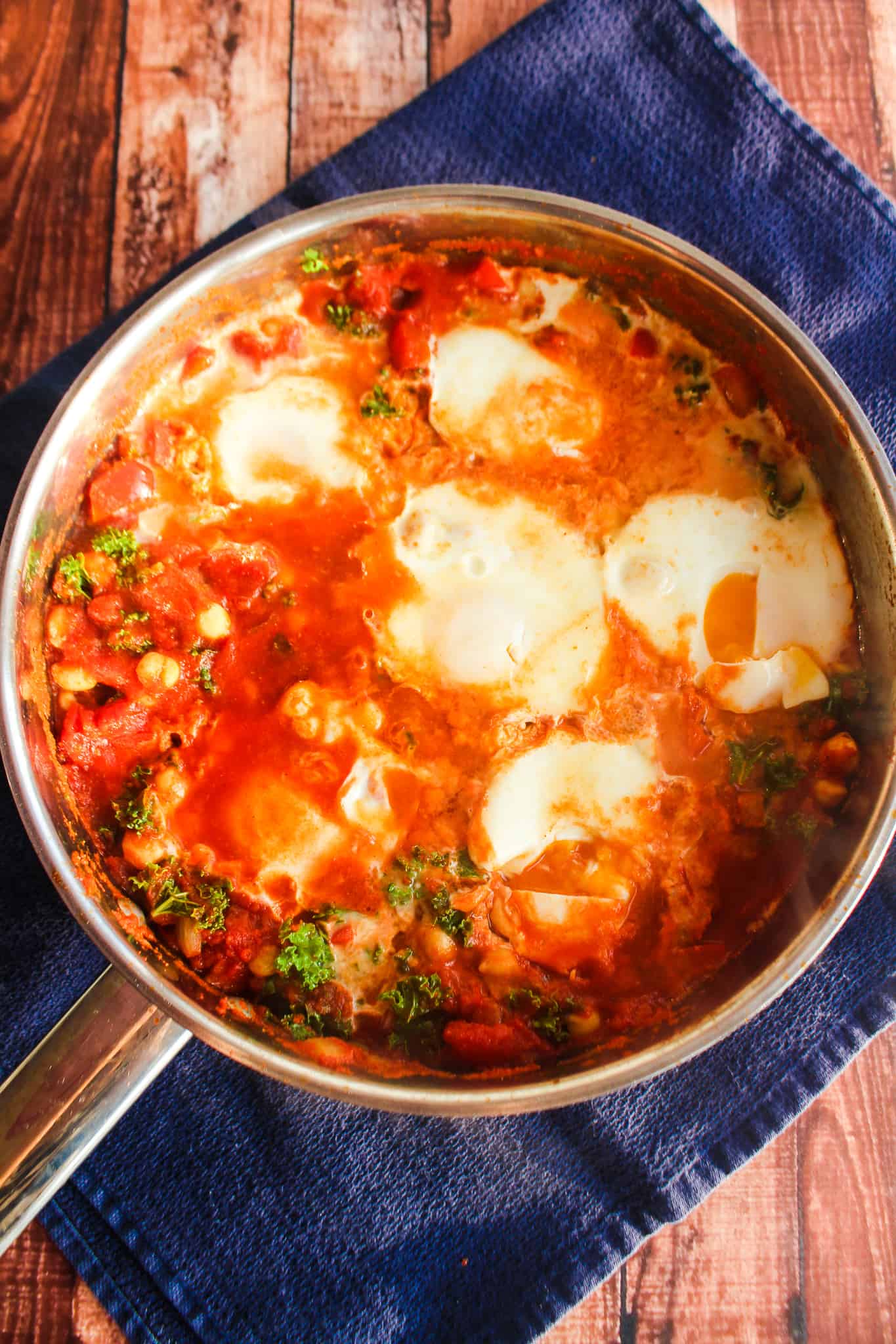 Skillet with finished dish with poached eggs.