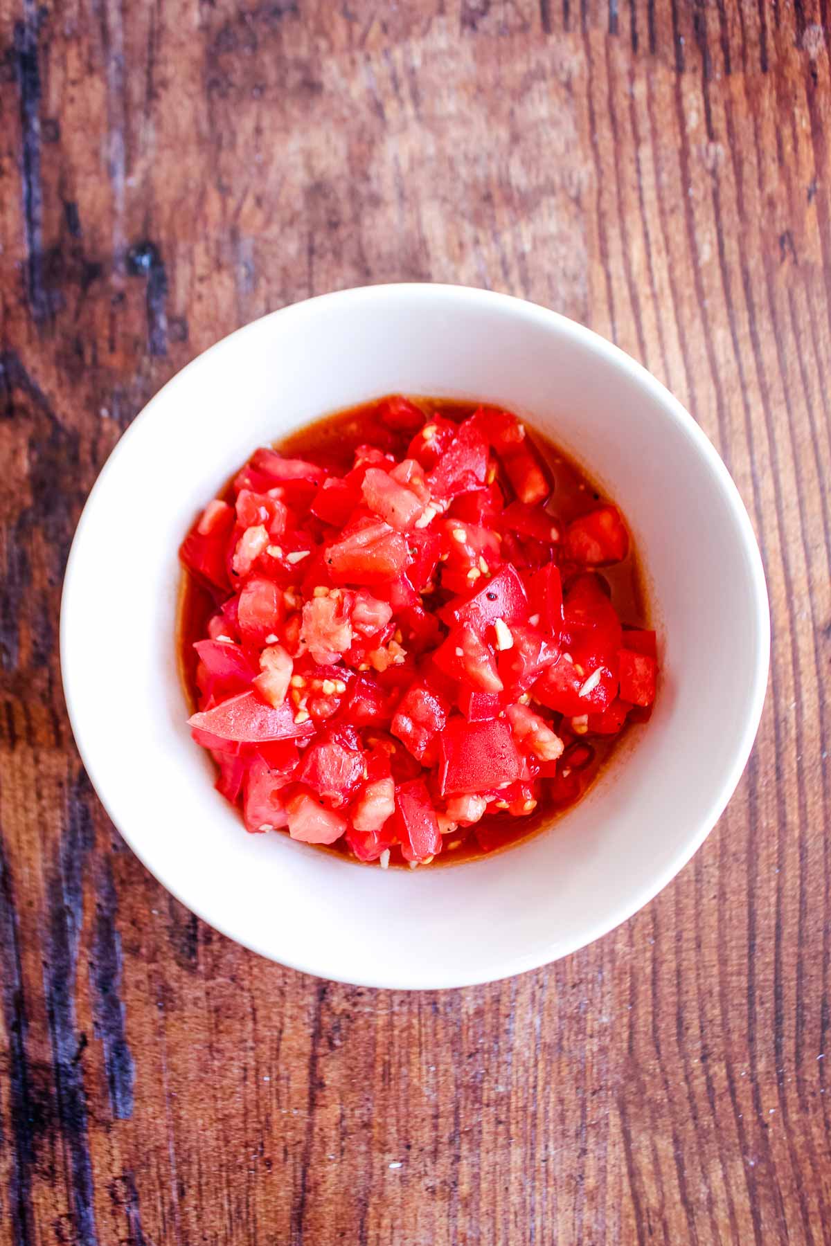 Chopped tomatoes to make bruschetta in a bowl.