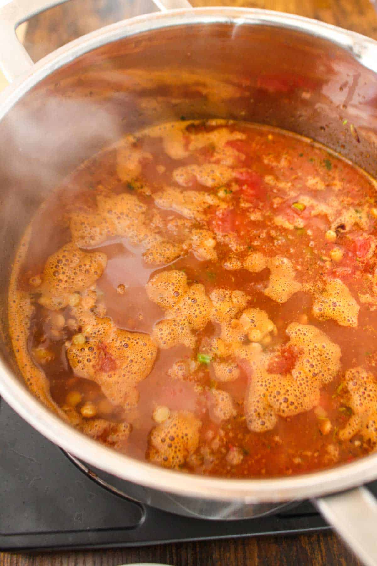 Broth and other ingredients added to the cooked veggies.