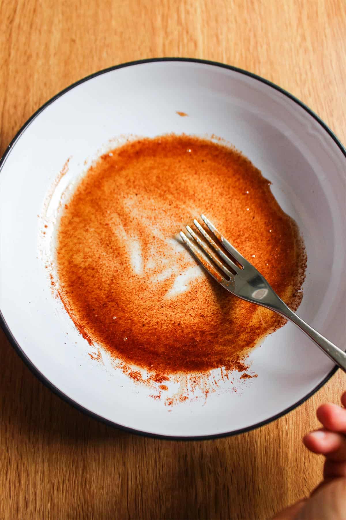 Mixing together the syrup and spices to make sweet and spicy pecans.