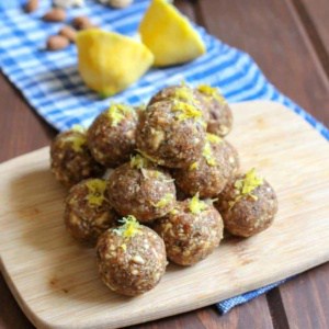 A stack of lemon protein balls on a cutting board.