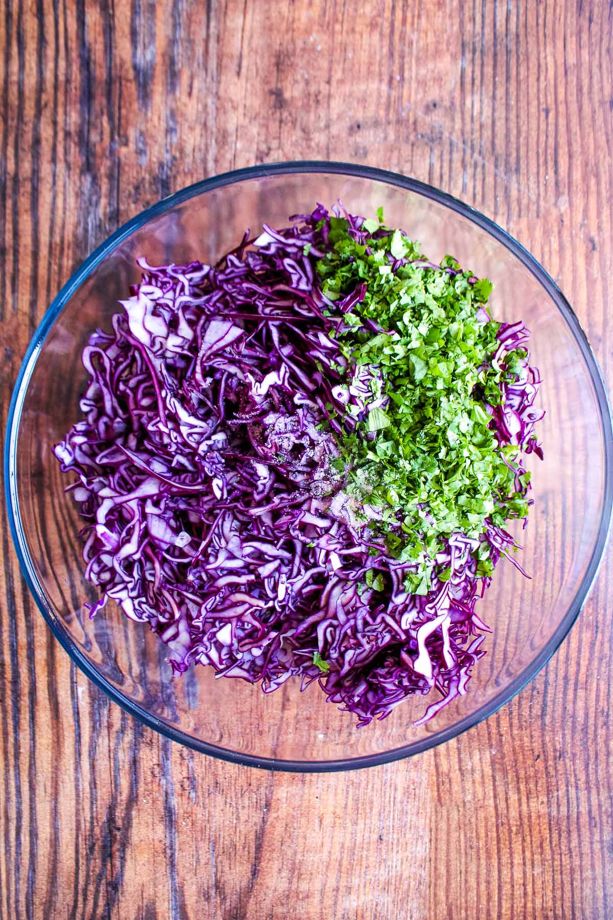 Cabbage and chopped cilantro in a bowl.