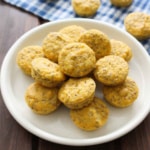 A plate piled up with lemon chia seed muffins on the table.