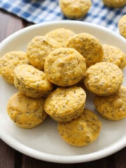 A plate piled up with lemon chia seed muffins on the table.
