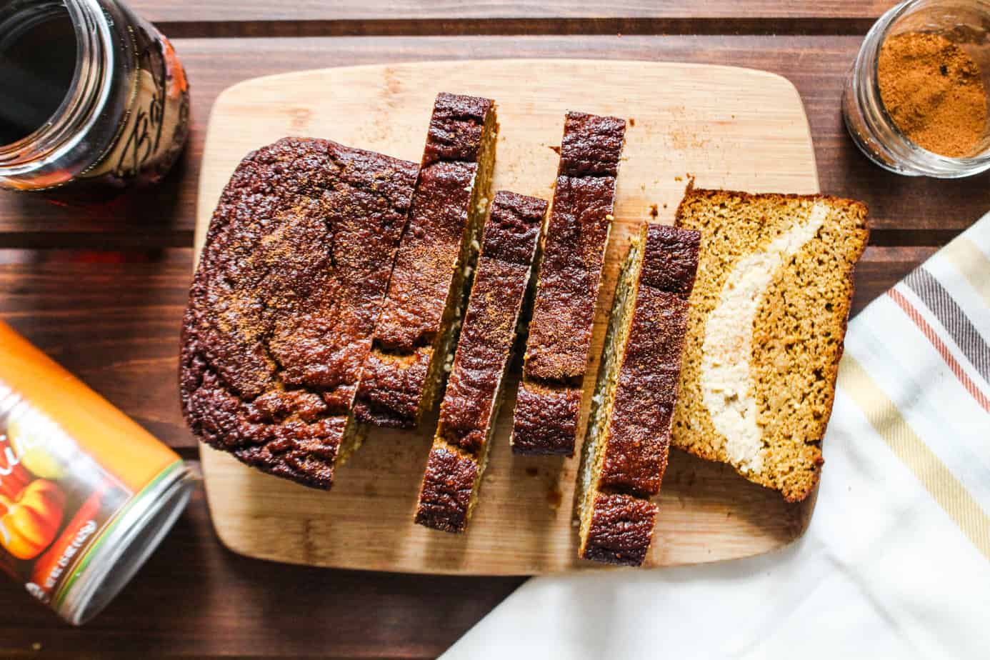 Sliced pumpkin bread with cheesecake filling on cutting board