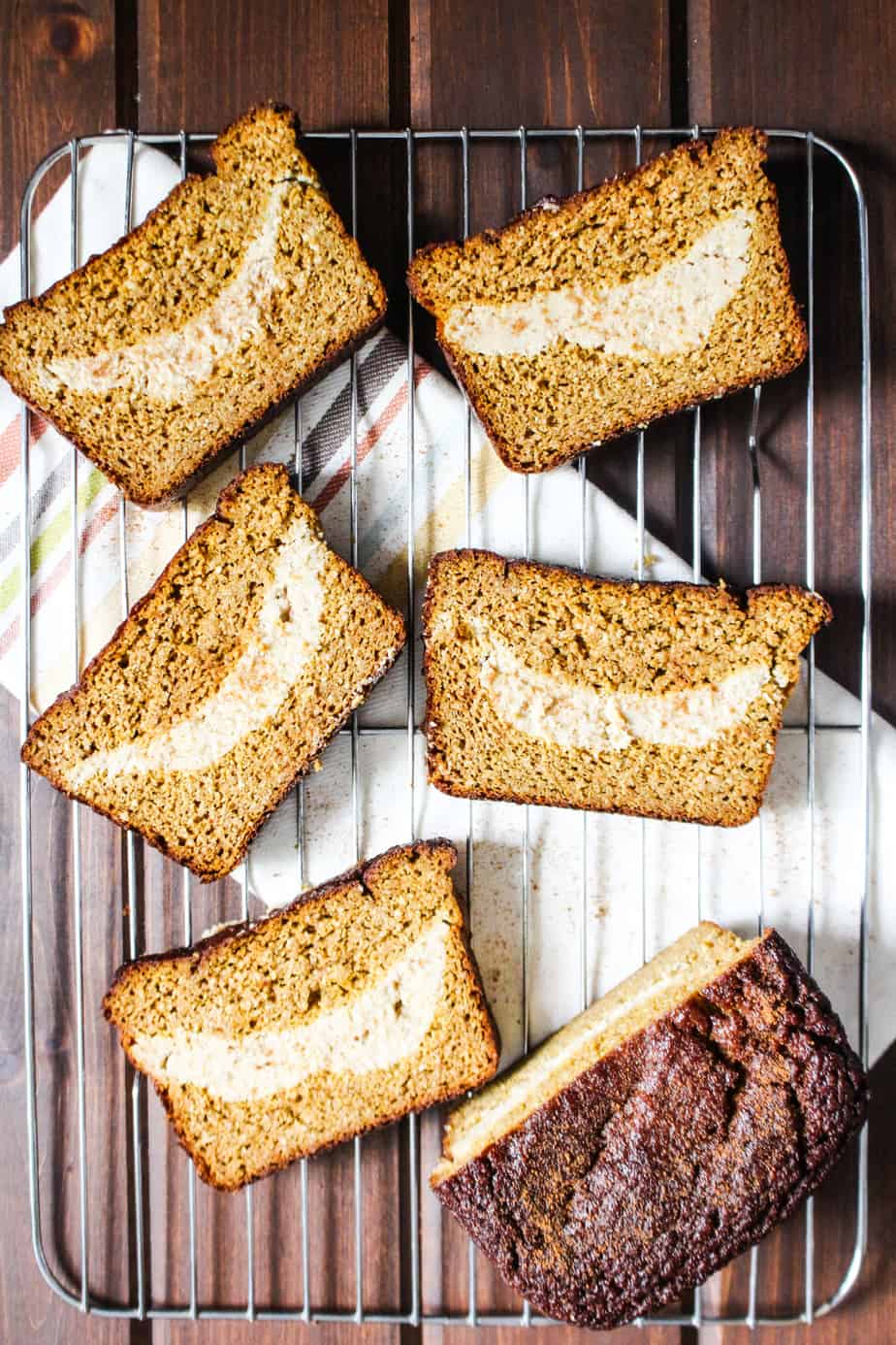 Wire cooling rack with five slices of pumpkin bread.