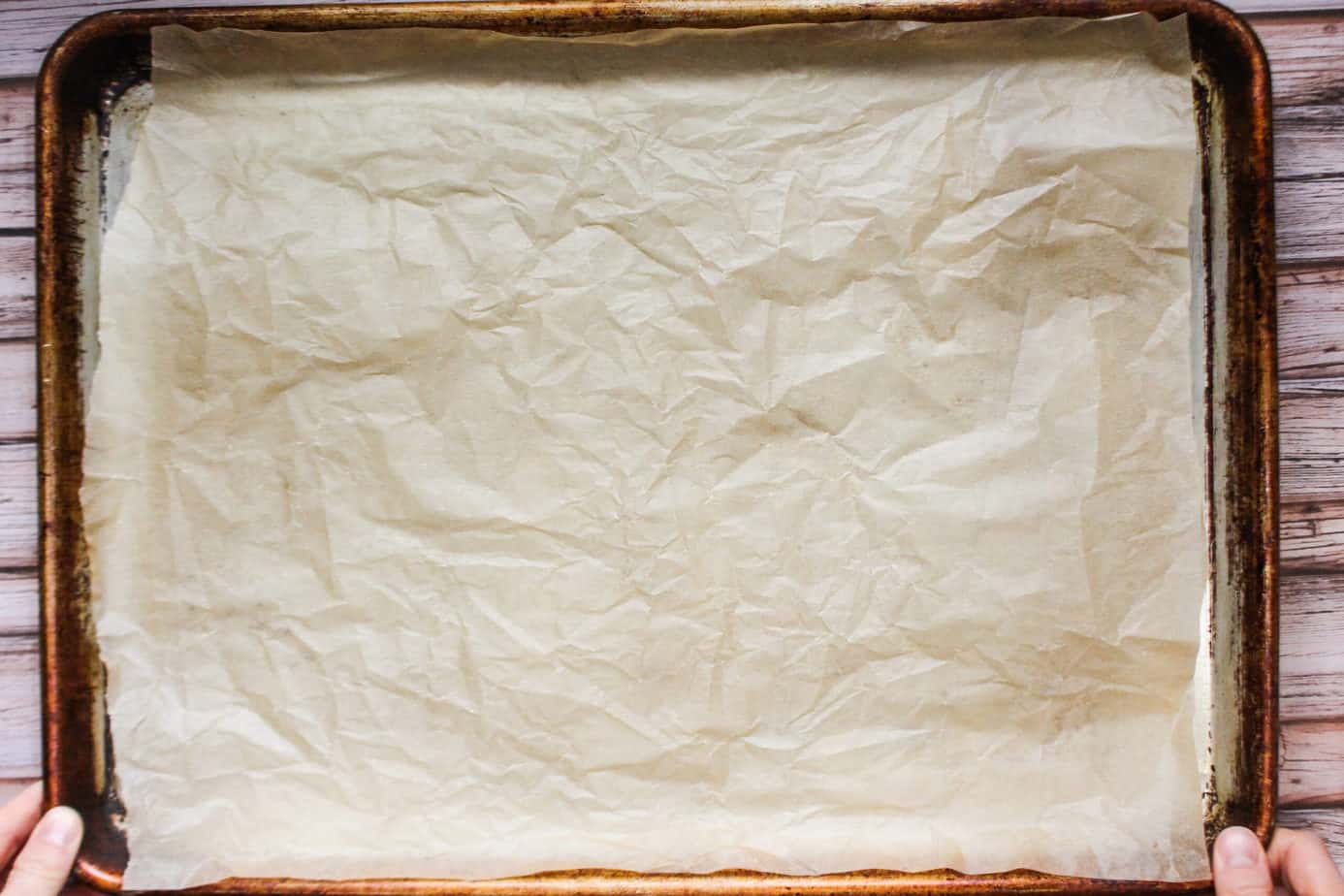 Wrinkled parchment paper on a sheet pan