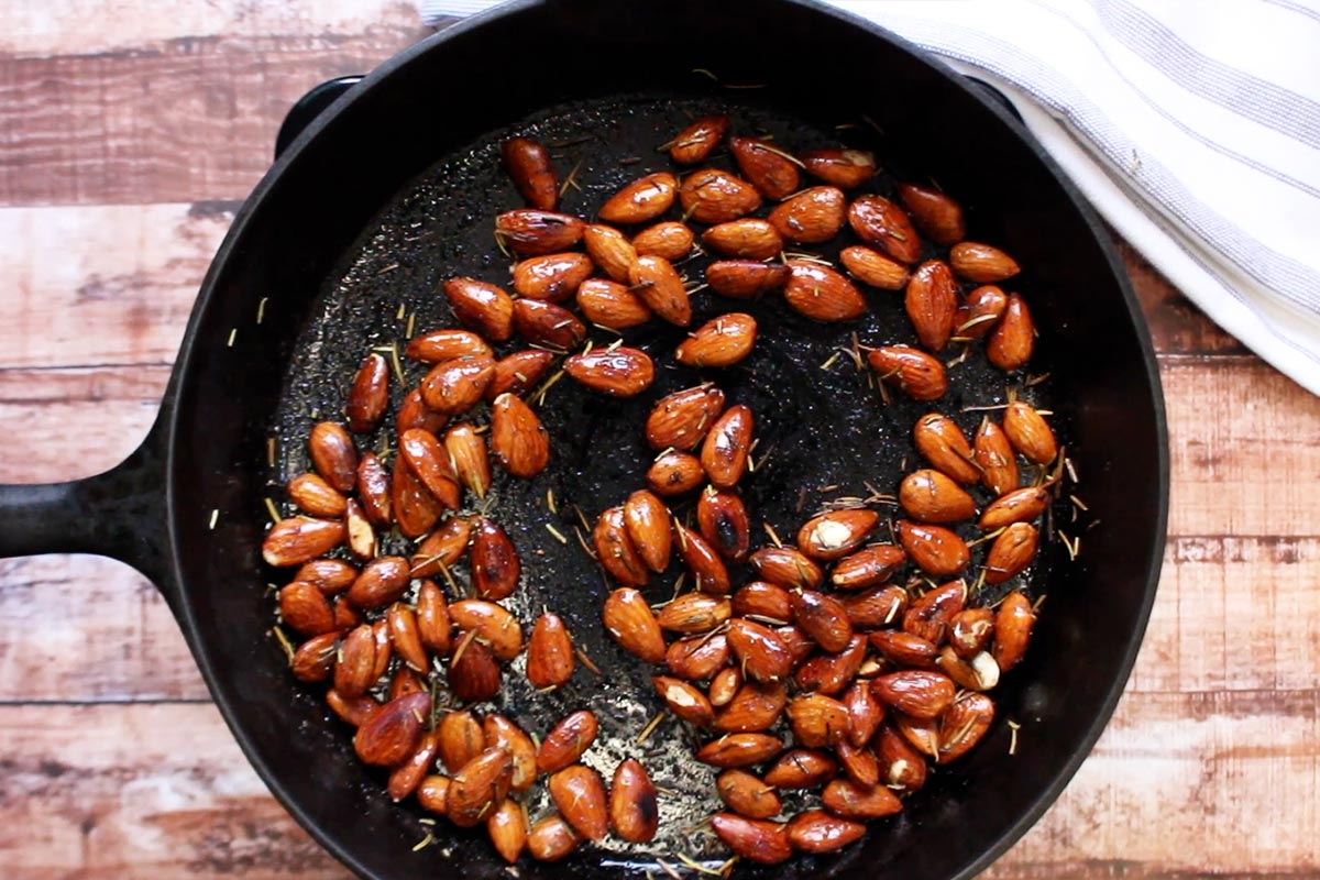 Toasted almonds are in the skillet after cooking.