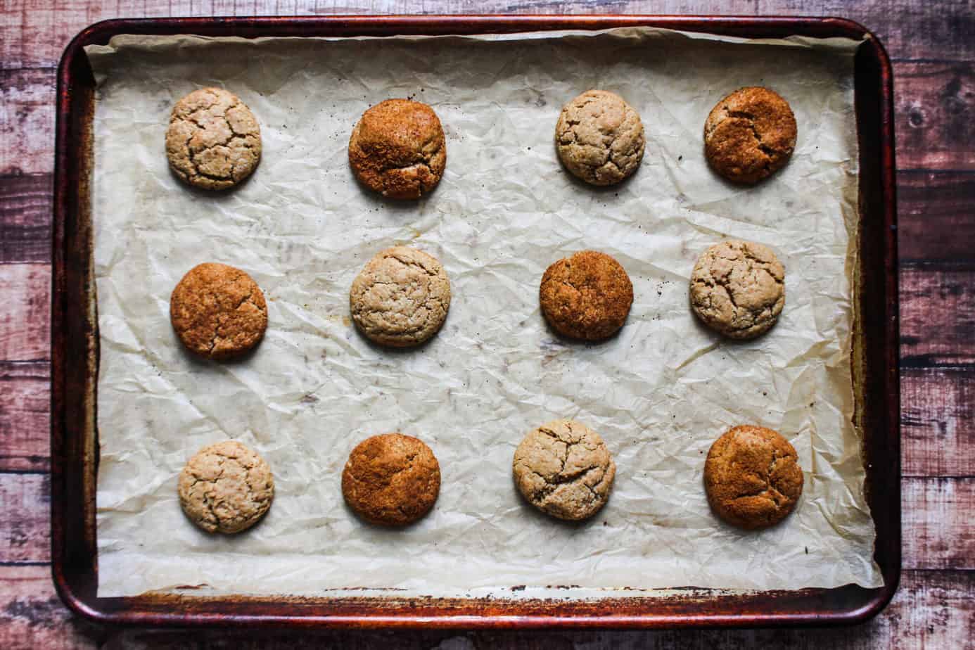 parchment lined sheet pan with 12 cookies