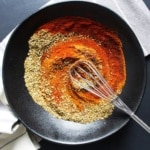 Spices to make chorizo seasoning in a bowl with a small whisk.