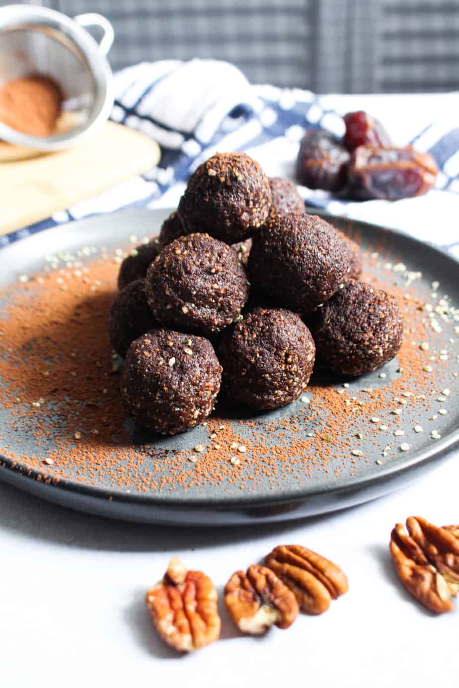 pile of chocolate truffles on plate, dusted with cocoa powder