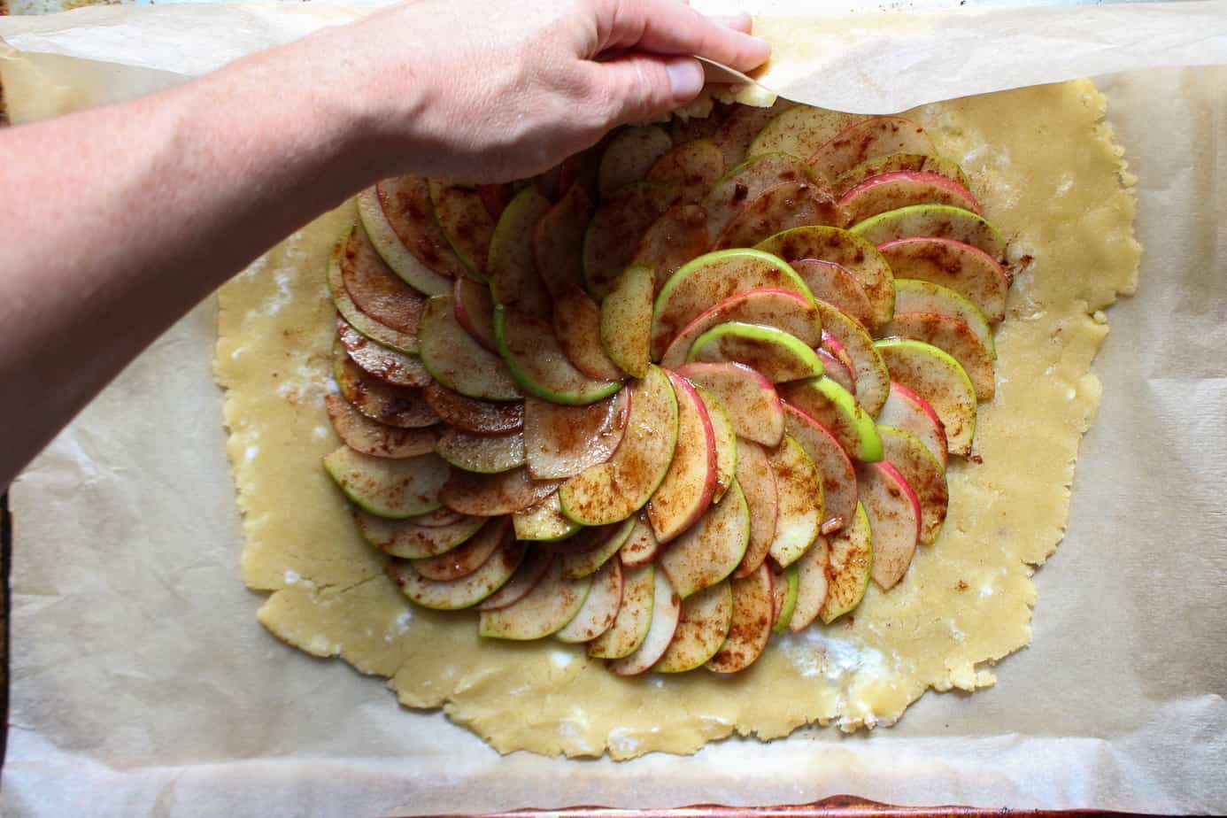 folding the edges of apple pie galette crust