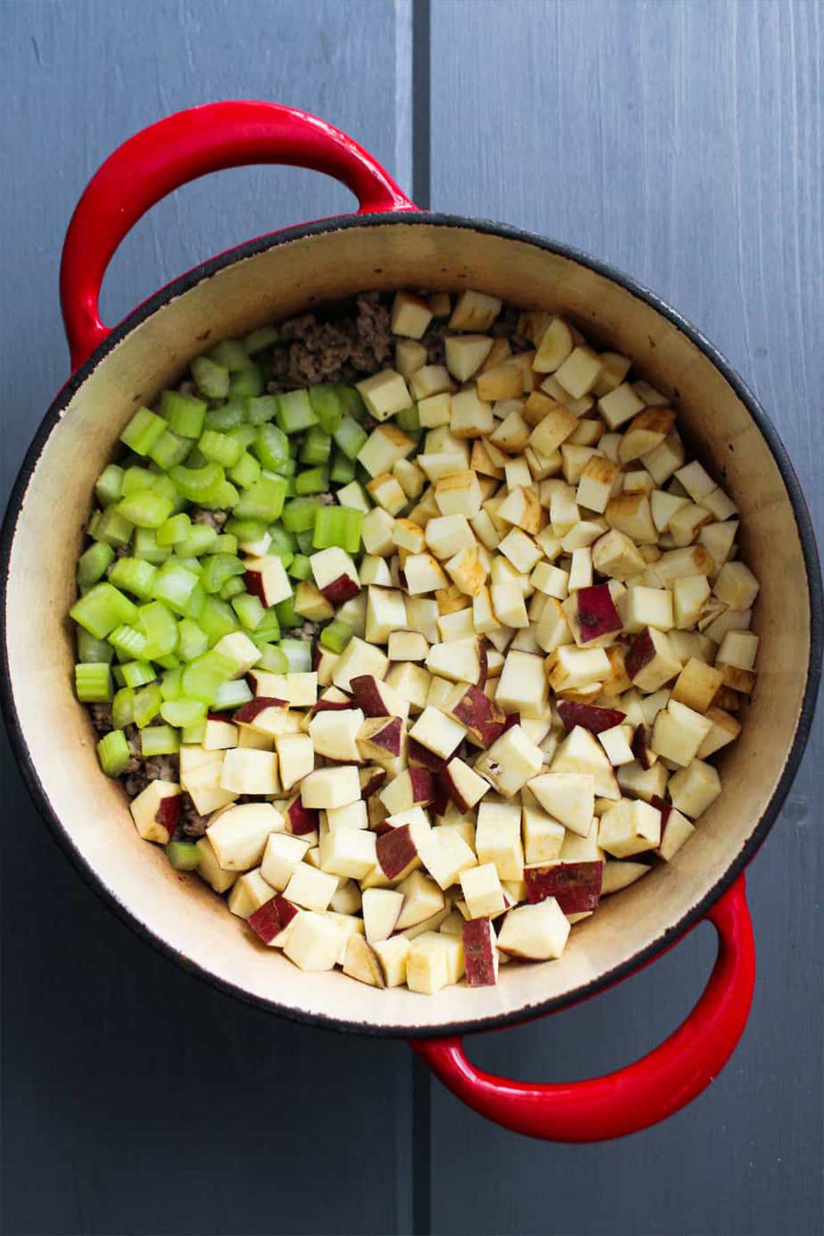 Potatoes, celery, and parsnips added to the pot with some brith.