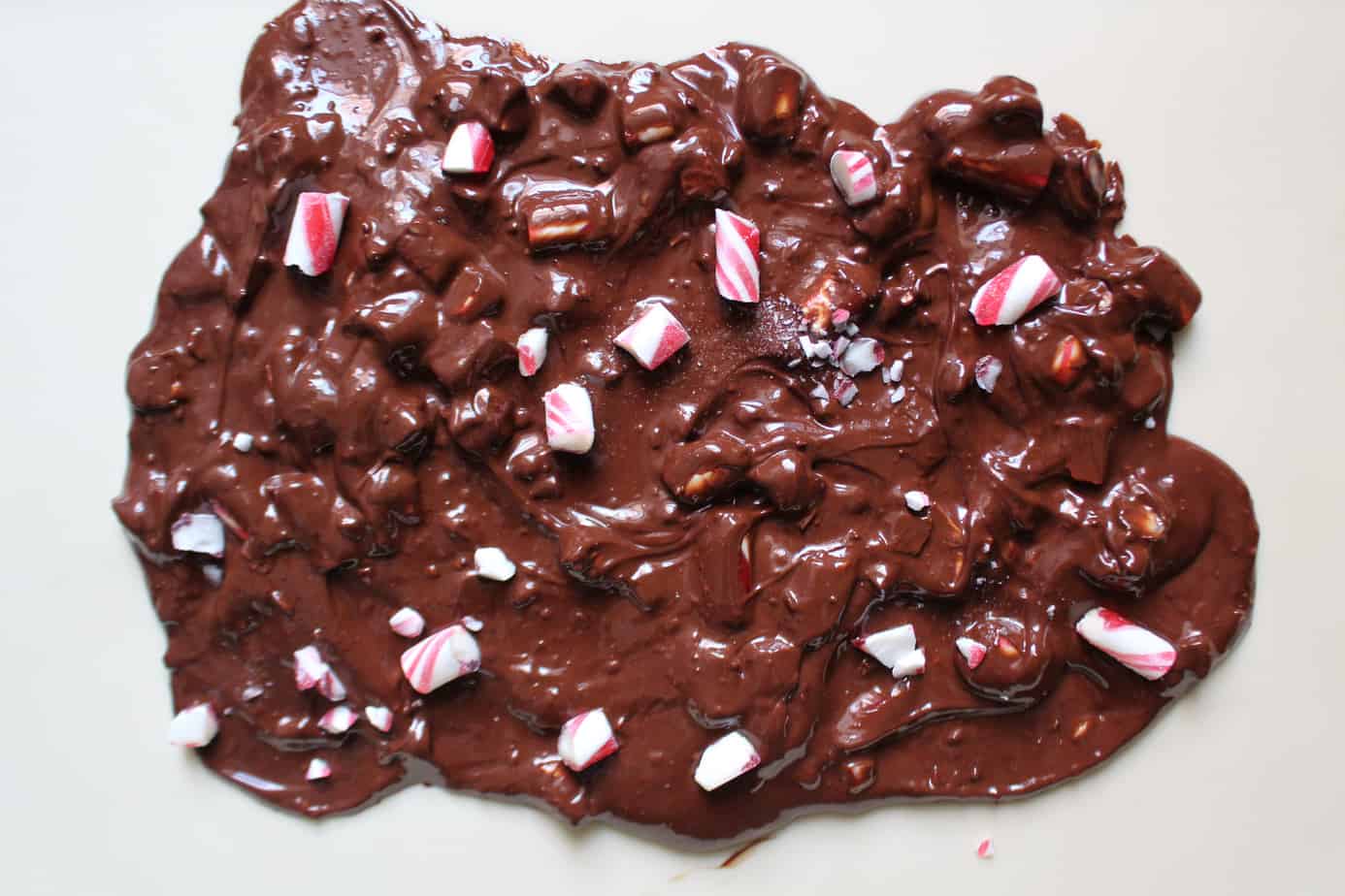 melted peppermint bark spread on parchment to set