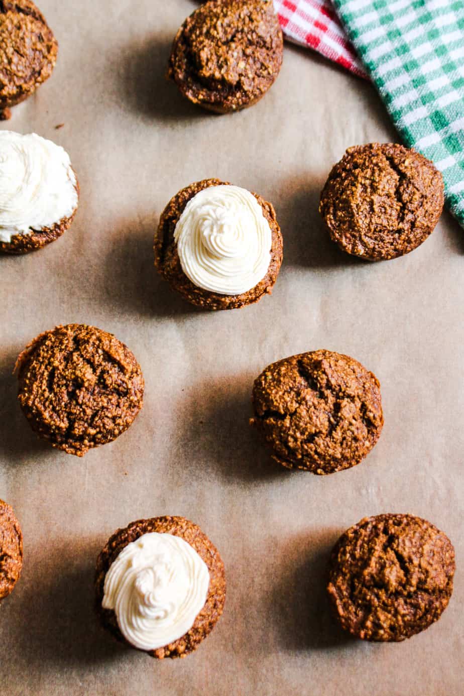 gingerbread muffins with cream cheese frosting on parchment paper