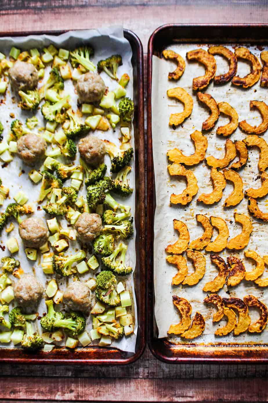 two sheet pans side by side, one with cooked broccoli florets and sausage meatballs, the other with cooked delicata squash