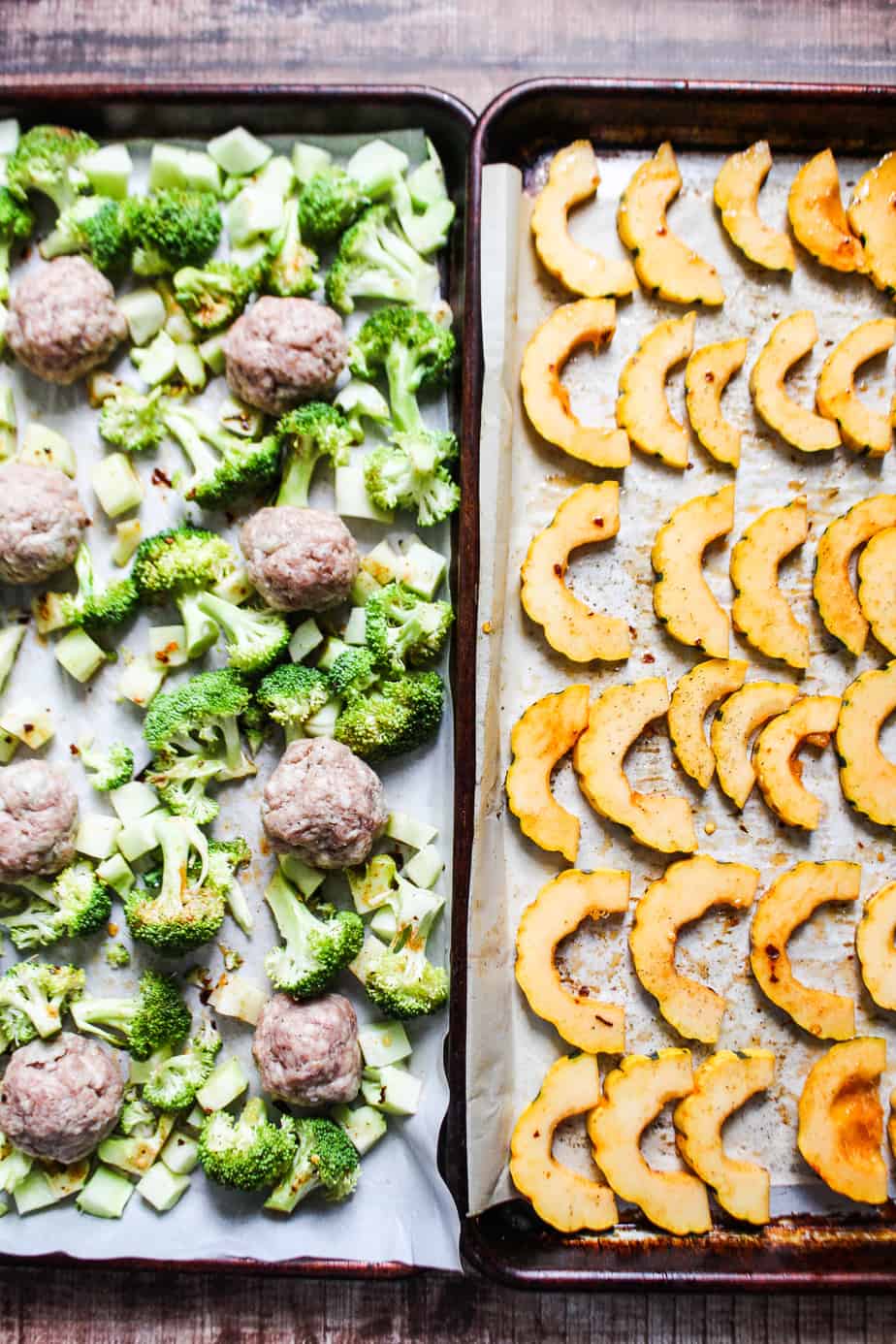 two sheetpans side by side, one with broccoli florets and sausage meatballs, the other with sliced delicata squash