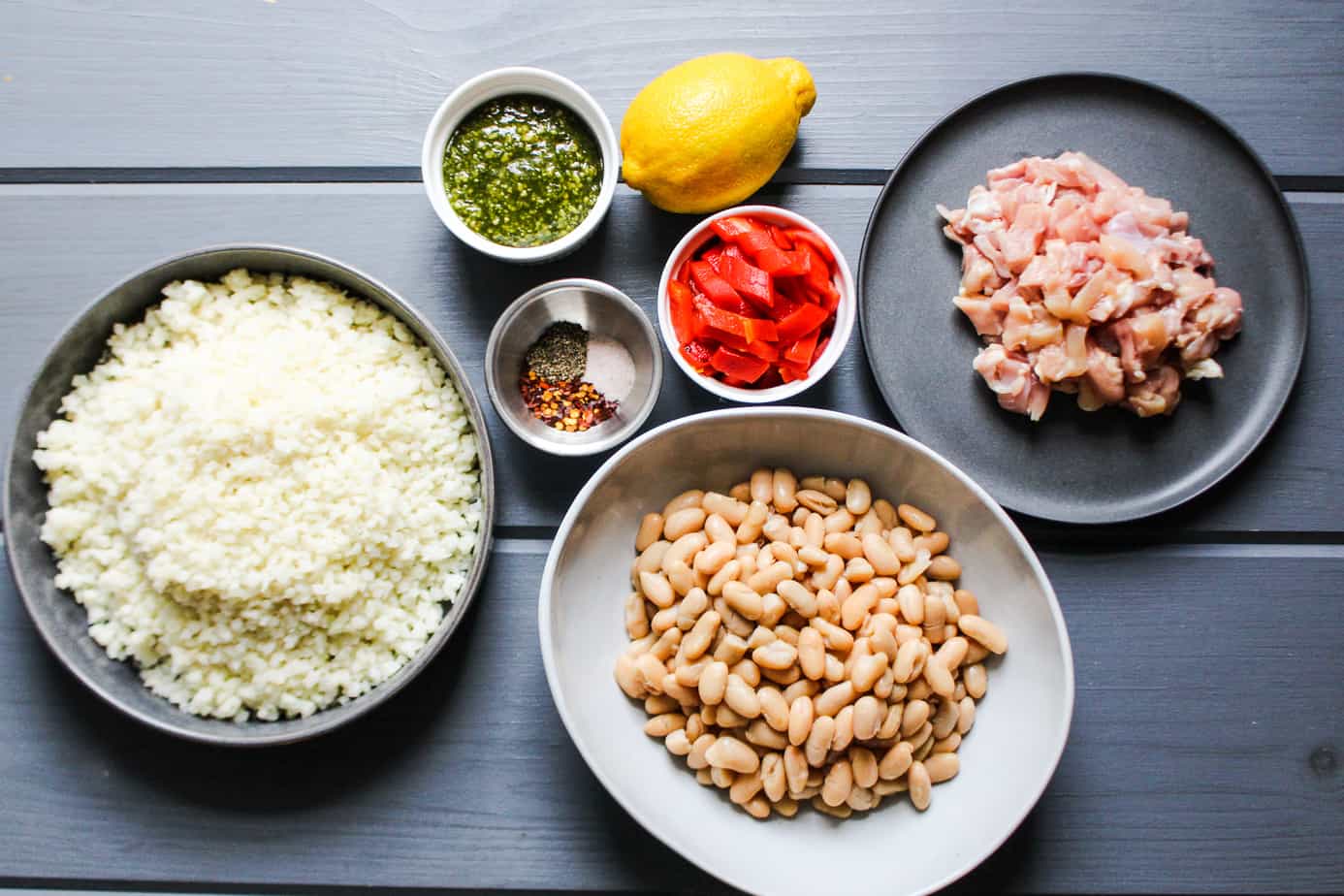 ingredients: cauliflower rice, pesto, spices, lemon, roasted red peppers, chicken, white beans