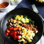 black bowl filled with paleo kale cobb salad