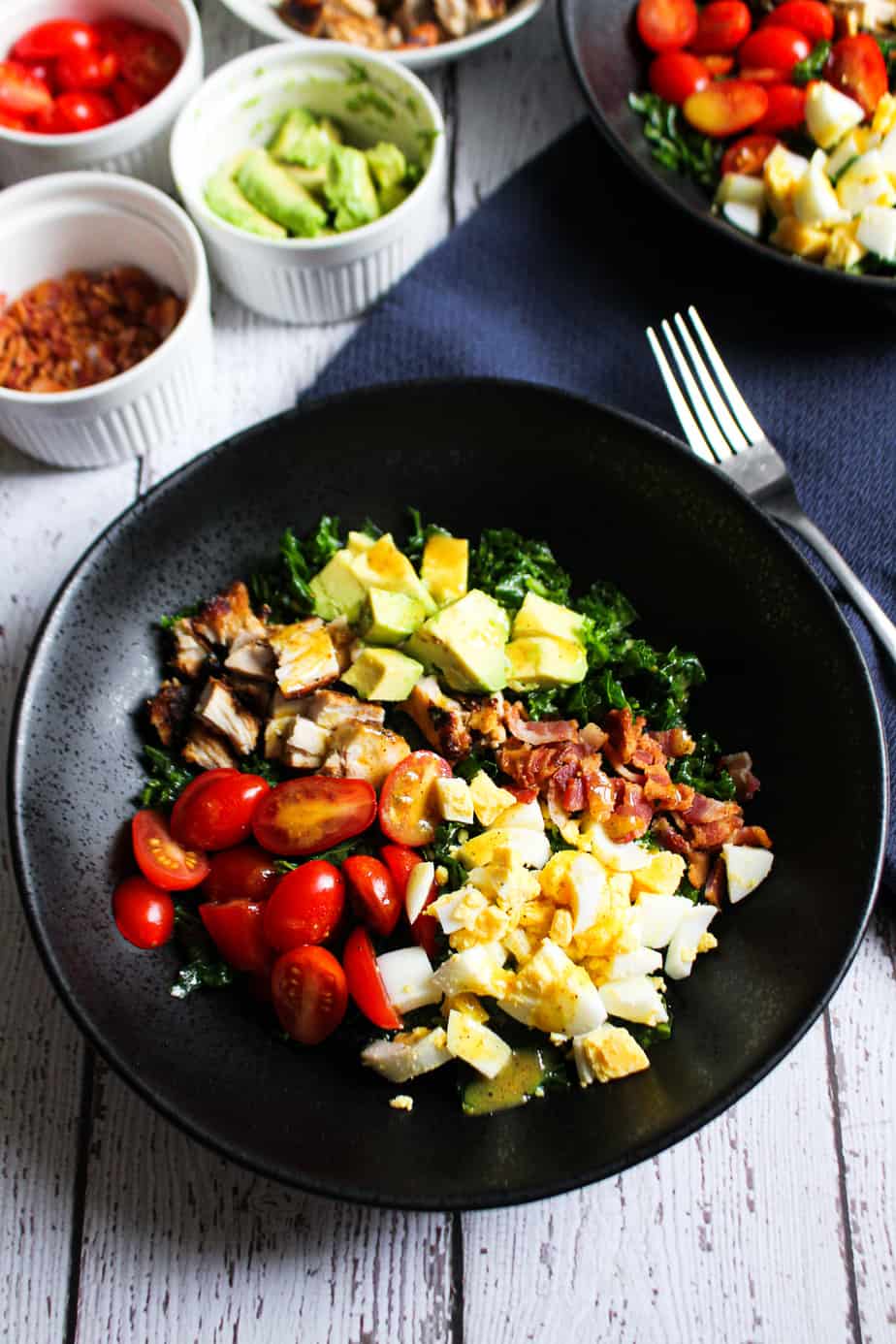 black bowl filled with paleo kale cobb salad